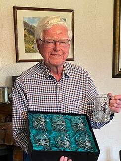 Aled Griffiths holding crystal glasses gift